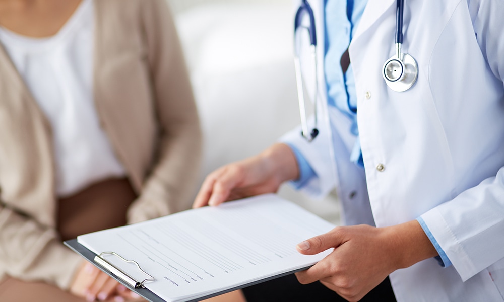 A doctor is holding a clipboard and talking to a patient. At Alliance, our team of medical professionals are dedicated to using their decades of experience and the latest innovations to provide the highest quality of care available.